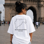Female wearing a white t-shirt with Maharashtra map design in front of a historical arch.