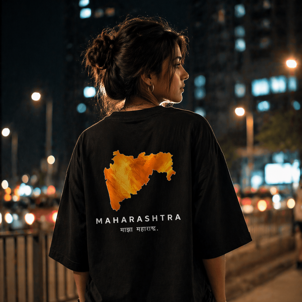 Person wearing a black t-shirt with Maharashtra map design on the back, standing in an urban night setting.