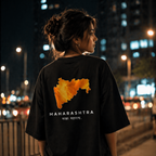 Person wearing a black t-shirt with Maharashtra map design on the back, standing in an urban night setting.