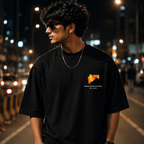 Person wearing a black t-shirt with a logo on a street at night